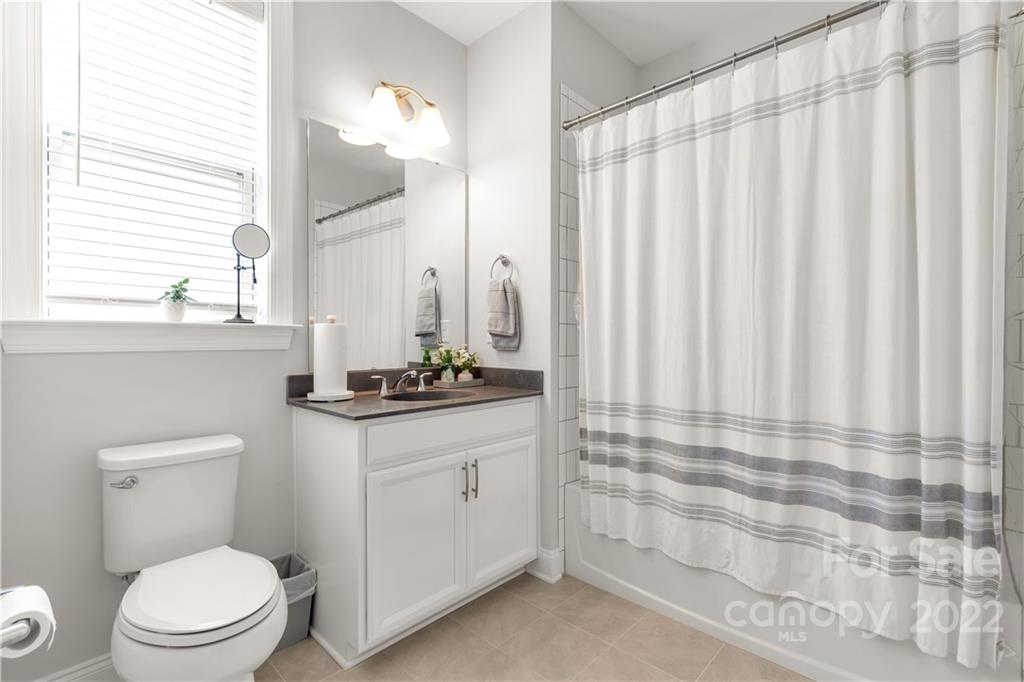 6028 Candlestick Lane Lancaster, SC 29720 - Photo 16 of 34 a bathroom with a toilet a sink and a mirror