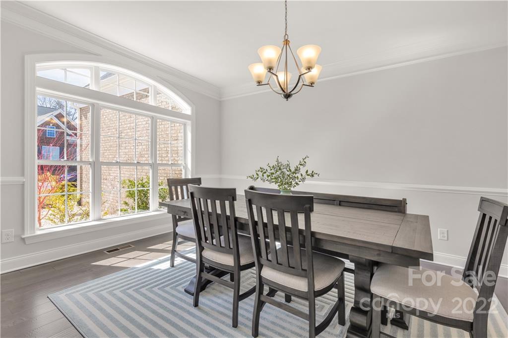 6028 Candlestick Lane Lancaster, SC 29720 - Photo 6 of 34 a view of a dining room with furniture a chandelier and wooden floor