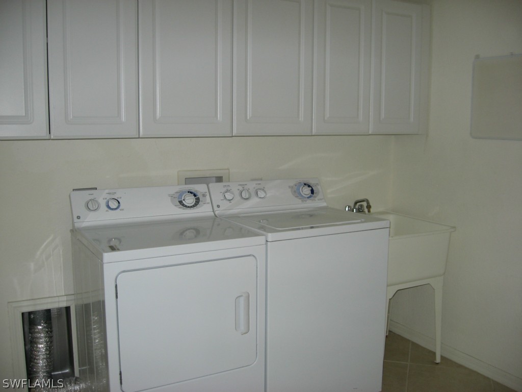 4676 Fairloop Run Lehigh Acres, FL 33973 - Photo 12 of 21 a utility room with dryer and washer