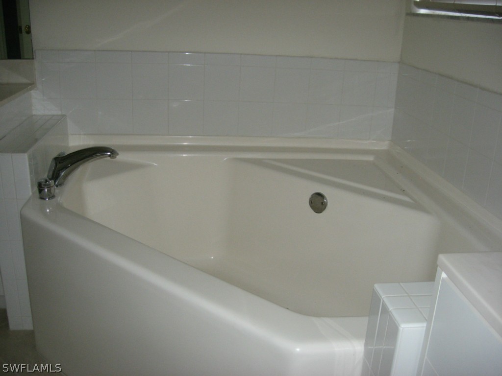 4676 Fairloop Run Lehigh Acres, FL 33973 - Photo 14 of 21 a close up of a bathtub