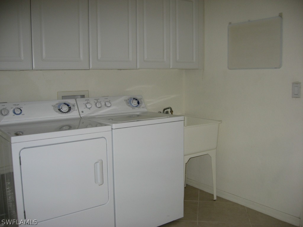 4676 Fairloop Run Lehigh Acres, FL 33973 - Photo 17 of 21 a utility room with dryer and washer