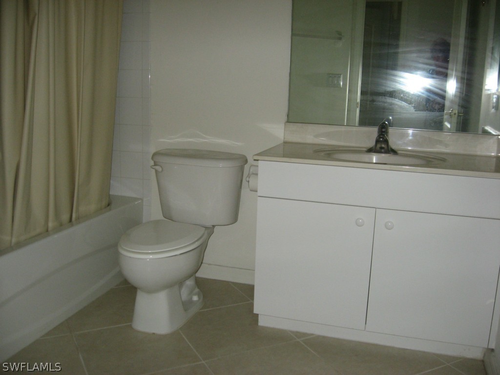 4676 Fairloop Run Lehigh Acres, FL 33973 - Photo 20 of 21 a bathroom with a toilet sink and mirror