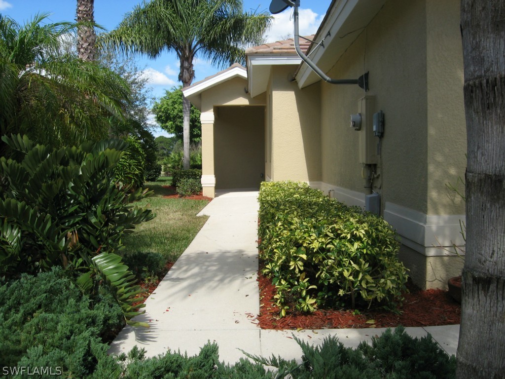 4676 Fairloop Run Lehigh Acres, FL 33973 - Photo 3 of 21 a view of a back yard with yellow house