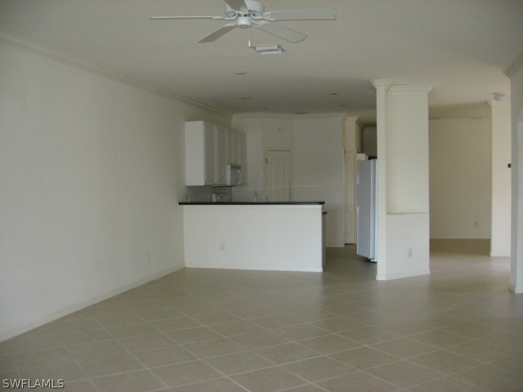 4676 Fairloop Run Lehigh Acres, FL 33973 - Photo 4 of 21 an empty room with a ceiling fan and chandelier fan