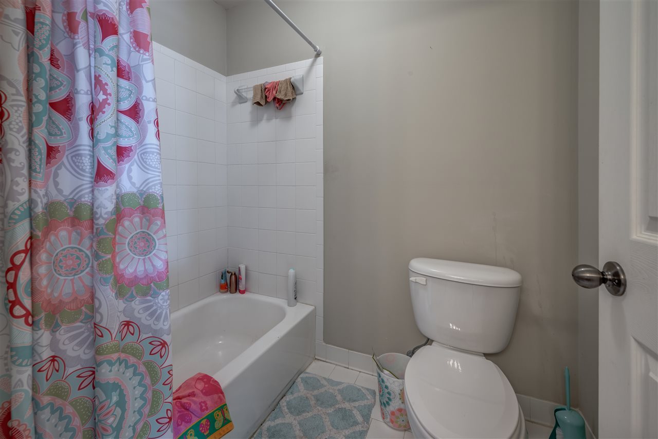 10388 Pilot Rock Road Collierville, TN 38017 - Photo 17 of 24 Private area with tile floor, toilet and tile shower walls at steel tub.