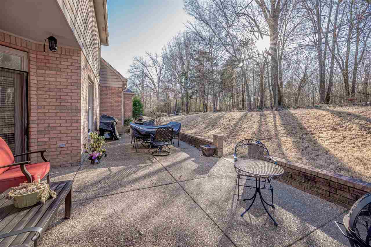 10388 Pilot Rock Road Collierville, TN 38017 - Photo 22 of 24 Nice covered patio with additional 12x30 patio with a brick border wall.