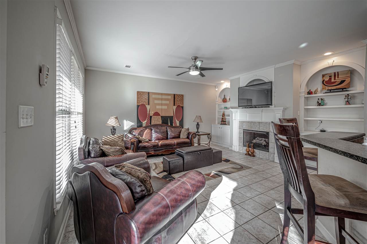 10388 Pilot Rock Road Collierville, TN 38017 - Photo 9 of 24 9 ft. ceiling with crown molding, tile floor, 2 recessed can lights at custom built-in cabinets, shelves and tv nook at tile fireplace with gas logs.