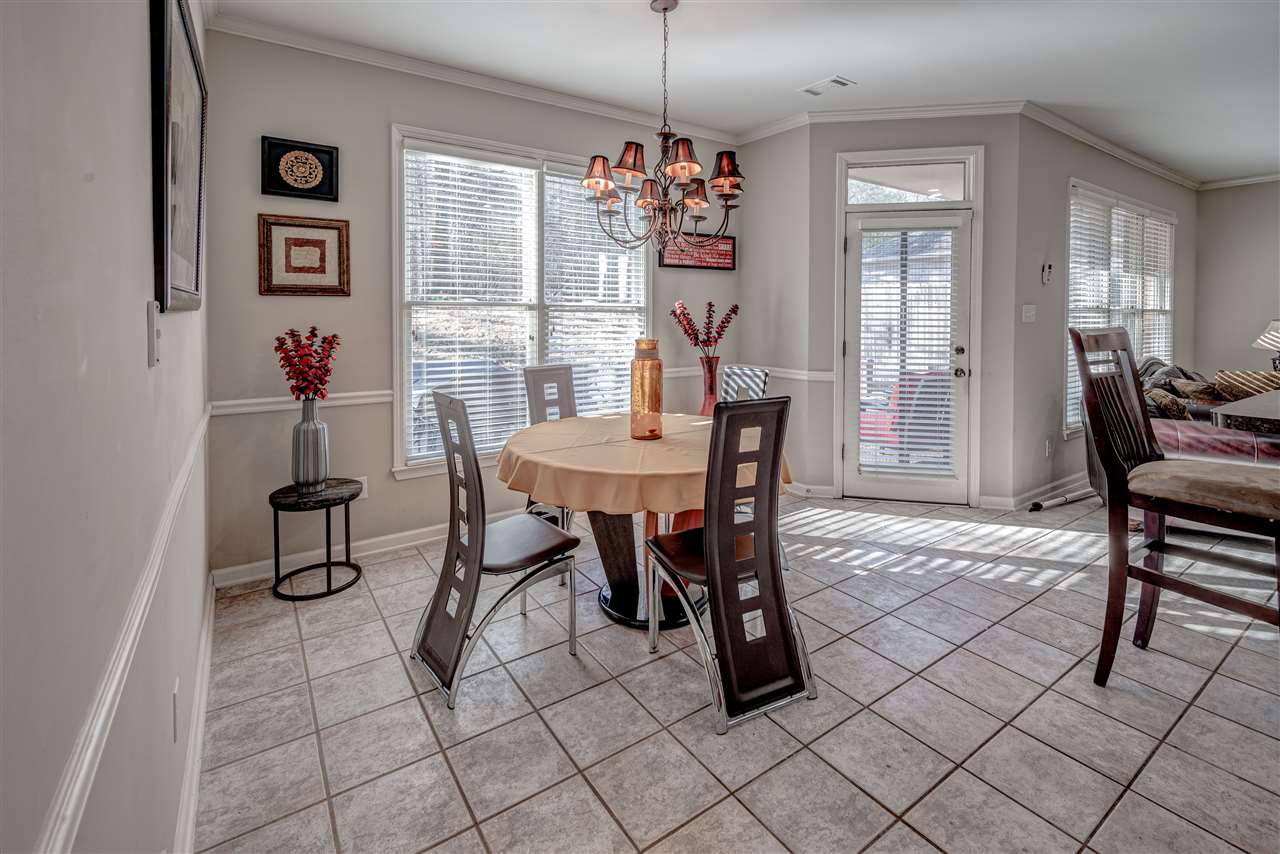10388 Pilot Rock Road Collierville, TN 38017 - Photo 10 of 24 9 ft. ceiling with crown molding, custom light fixture, tile floor, chair rail, double window with view of back yard and door to covered patio