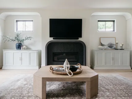 a living room with furniture a flat screen tv and a fireplace