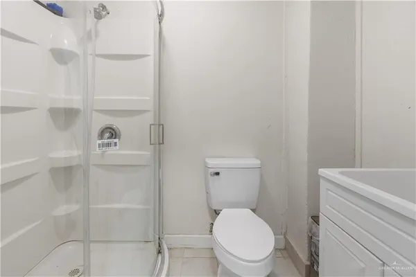a bathroom with a toilet a sink and shower