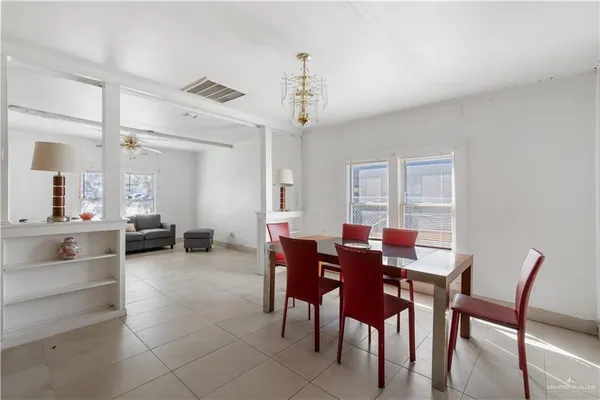 a view of a dining room with furniture and chandelier