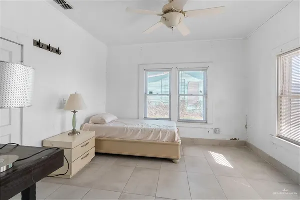 a spacious bedroom with a bed and a window