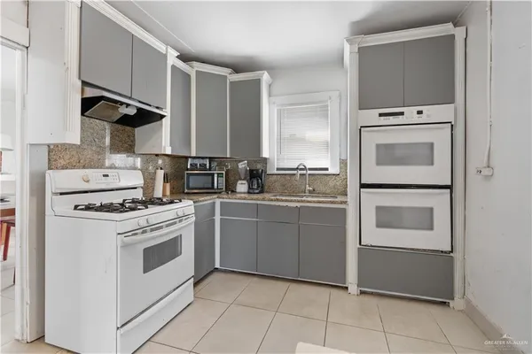 a kitchen with cabinets and white appliances