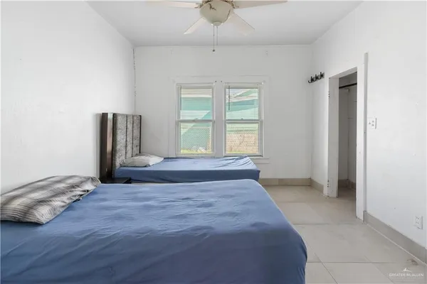 a spacious bedroom with a bed and a window