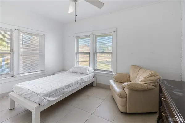 a bedroom with a bed and a couch