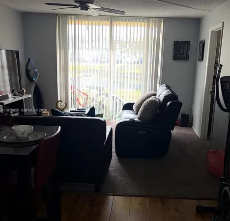 a living room with furniture window and a flat screen tv