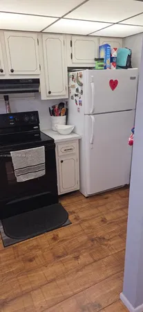 a white refrigerator freezer sitting in a kitchen