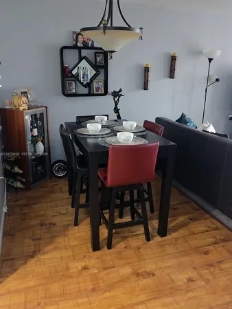 a dining room with a wooden table and chairs