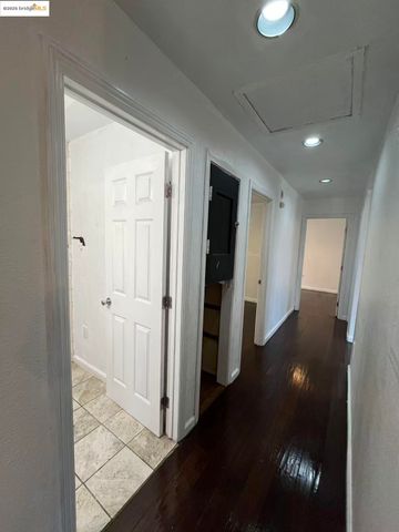 a living room with furniture a flat screen tv and kitchen view