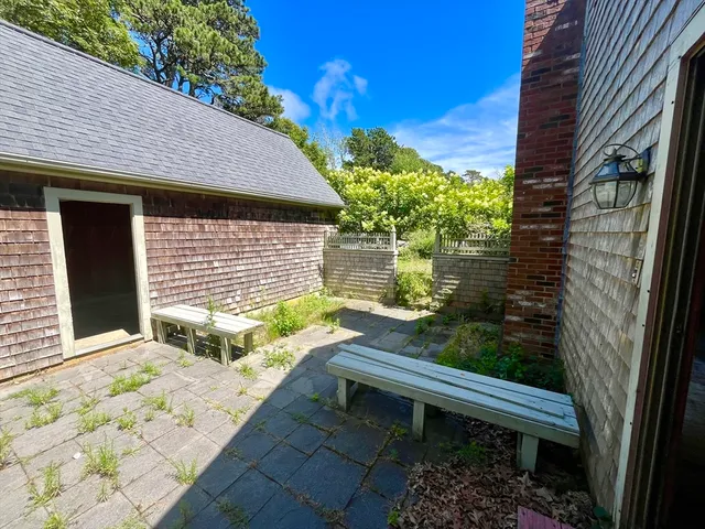 a wooden bench sitting in front of a house