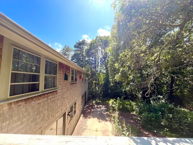 a balcony view with large trees