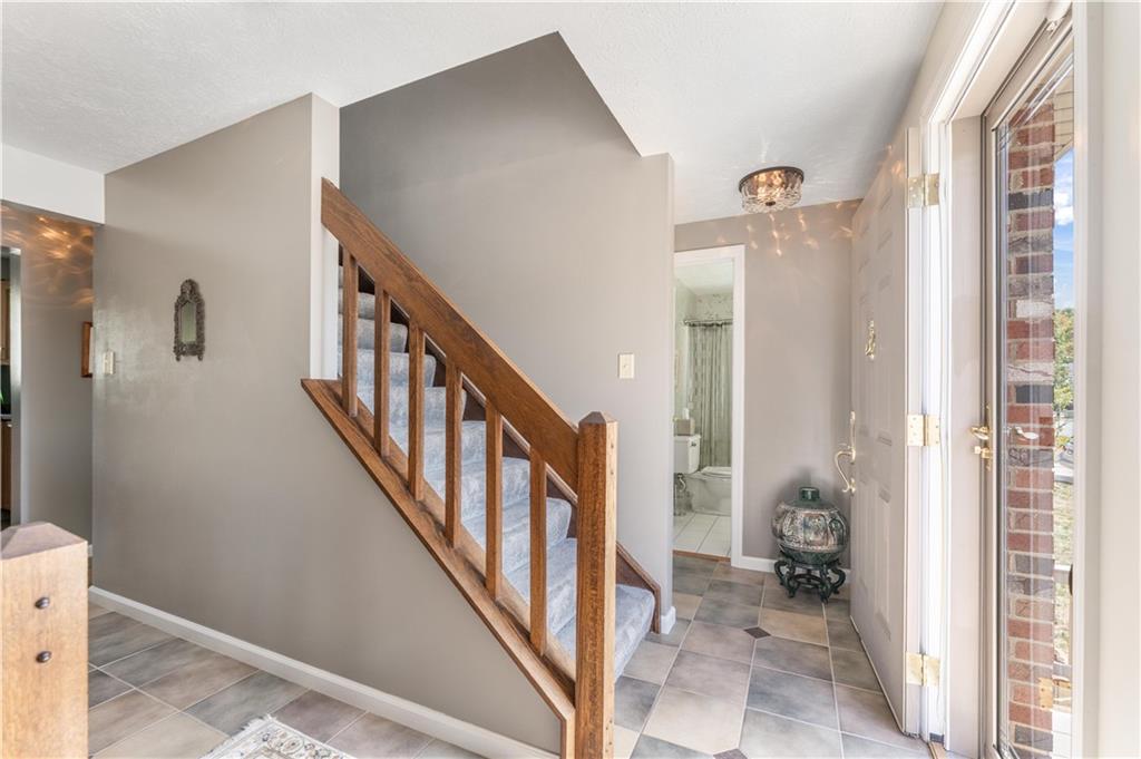 79 Fawnvue Drive McKees Rocks, PA 15136 - Photo 4 of 33 a view of a hallway with wooden floor and stairs