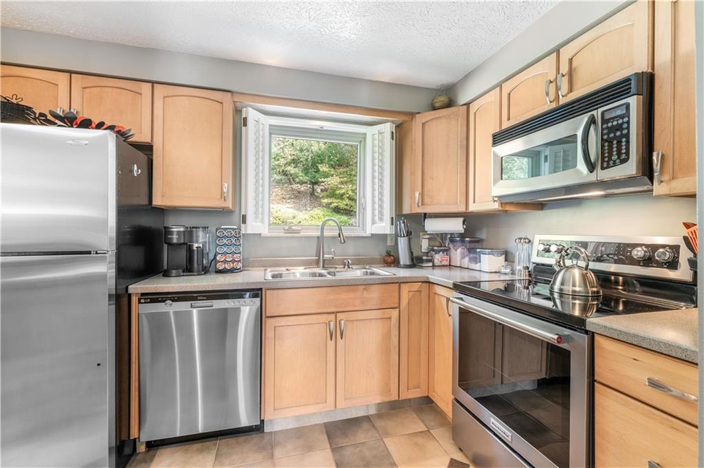79 Fawnvue Drive McKees Rocks, PA 15136 - Photo 10 of 33 a kitchen with a sink stove and microwave