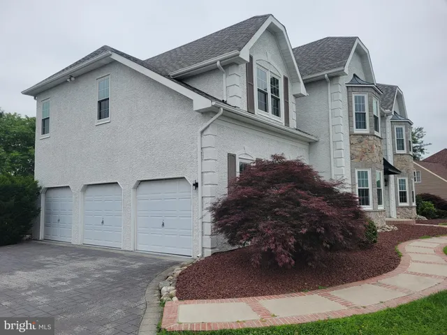 a view of a house with a yard and garage
