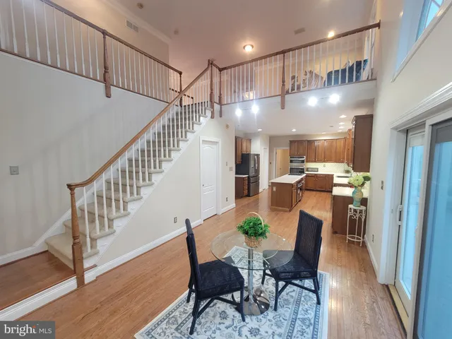 a dining room with furniture and wooden floor