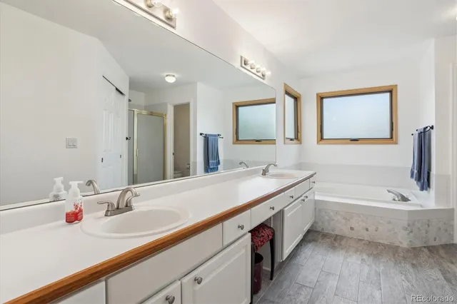 a bathroom with 2 sink and a bathtub
