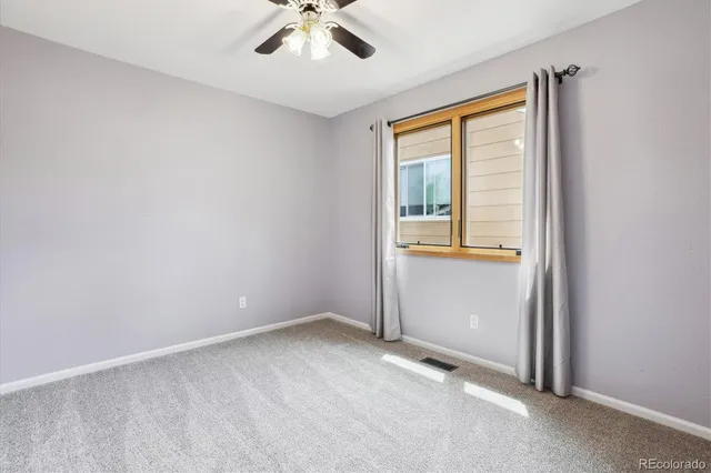 a bathroom with a granite countertop sink toilet a mirror and shower