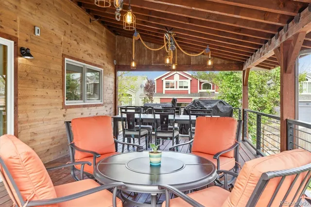 a view of a patio with table and chairs and wooden floor