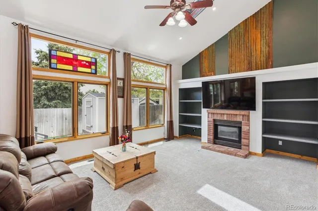a living room with furniture large window and a flat screen tv