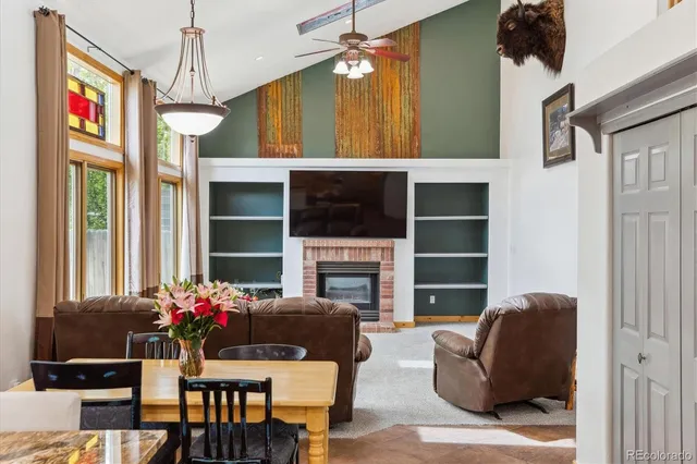 a living room with furniture a chandelier and a flat screen tv