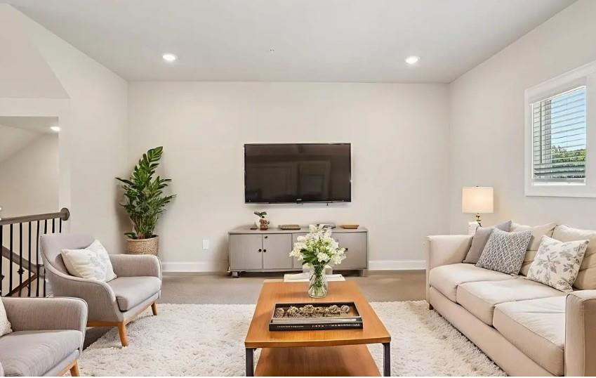 5960 Molo Lane Cumming, GA 30041 - Photo 11 of 17 a living room with furniture a flat screen tv and a window