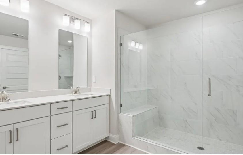 5960 Molo Lane Cumming, GA 30041 - Photo 14 of 17 a bathroom with a double vanity sink mirror and shower