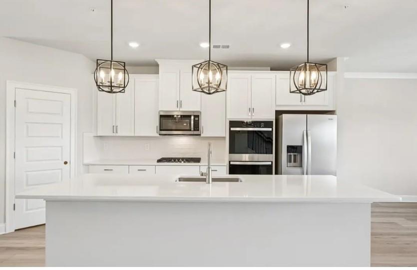 5960 Molo Lane Cumming, GA 30041 - Photo 4 of 17 a kitchen with stainless steel appliances granite countertop a refrigerator a stove a sink and a microwave