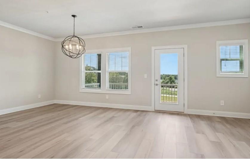 5960 Molo Lane Cumming, GA 30041 - Photo 6 of 17 a view of an empty room with wooden floor and a window