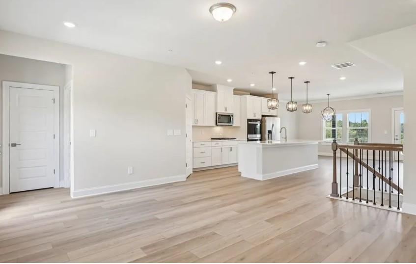 5960 Molo Lane Cumming, GA 30041 - Photo 9 of 17 a view of kitchen dining table kitchen island with cabinets and wooden floor
