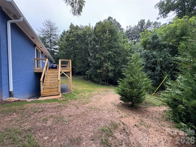 a backyard of a house with plants and entertaining space