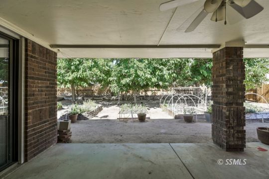 1257 Carolyn Street Ridgecrest, CA 93555 - Photo 35 of 42 a living room with patio furniture and a floor to ceiling window