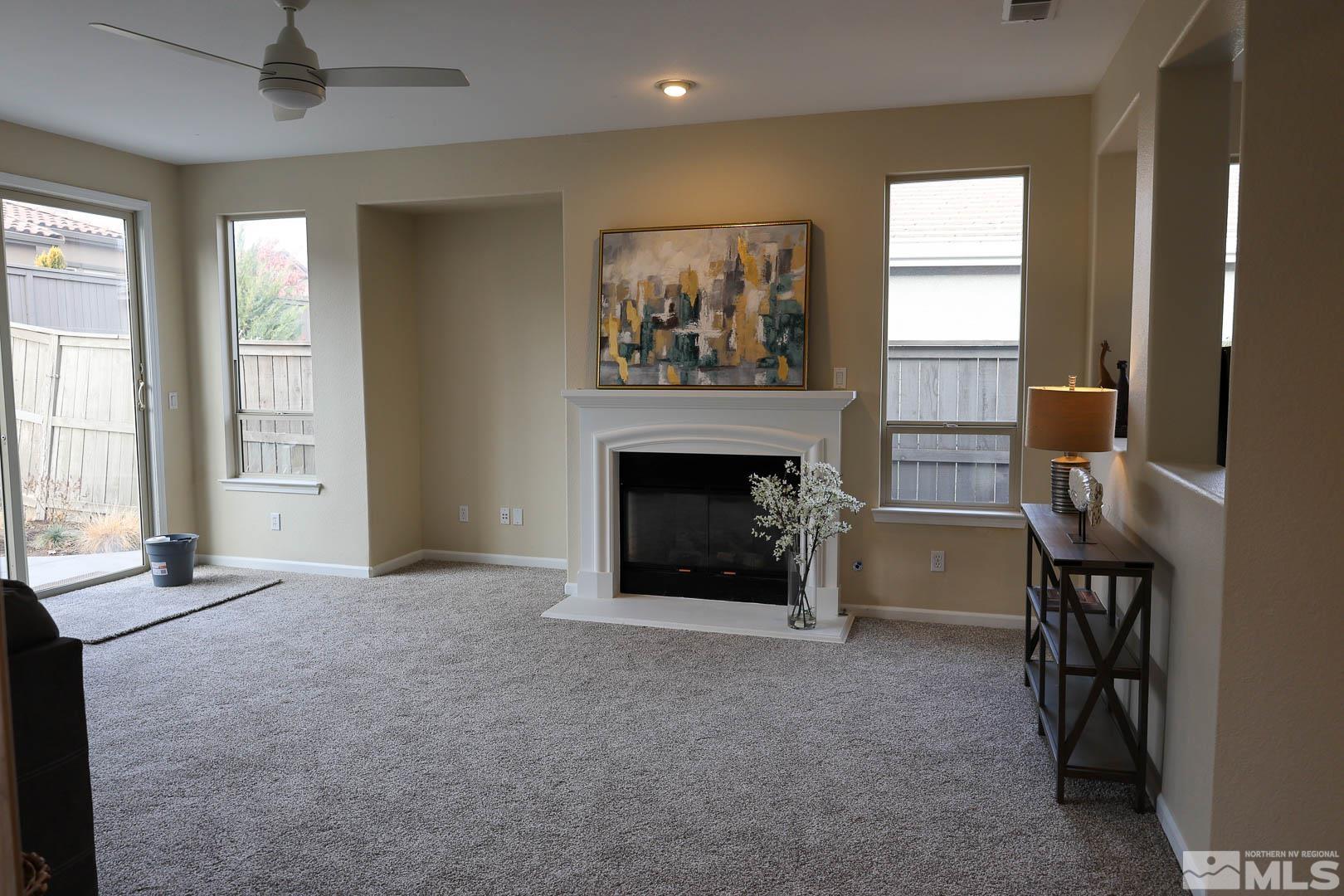 540 Beckfield Court Reno, NV 89521 - Photo 13 of 23 an empty room with windows and fireplace