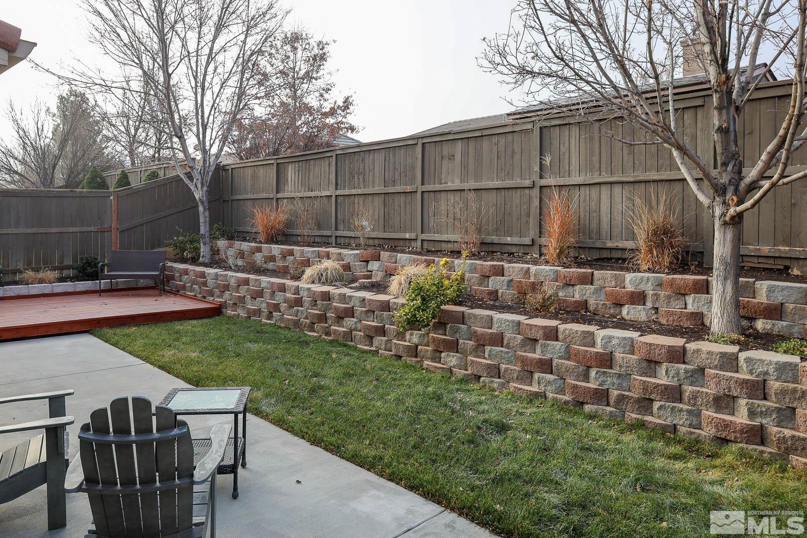 540 Beckfield Court Reno, NV 89521 - Photo 18 of 23 a view of backyard with table and chairs and potted plants