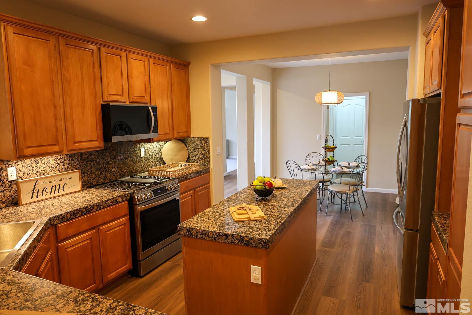 540 Beckfield Court Reno, NV 89521 - Photo 6 of 23 a kitchen with a stove a sink and a refrigerator