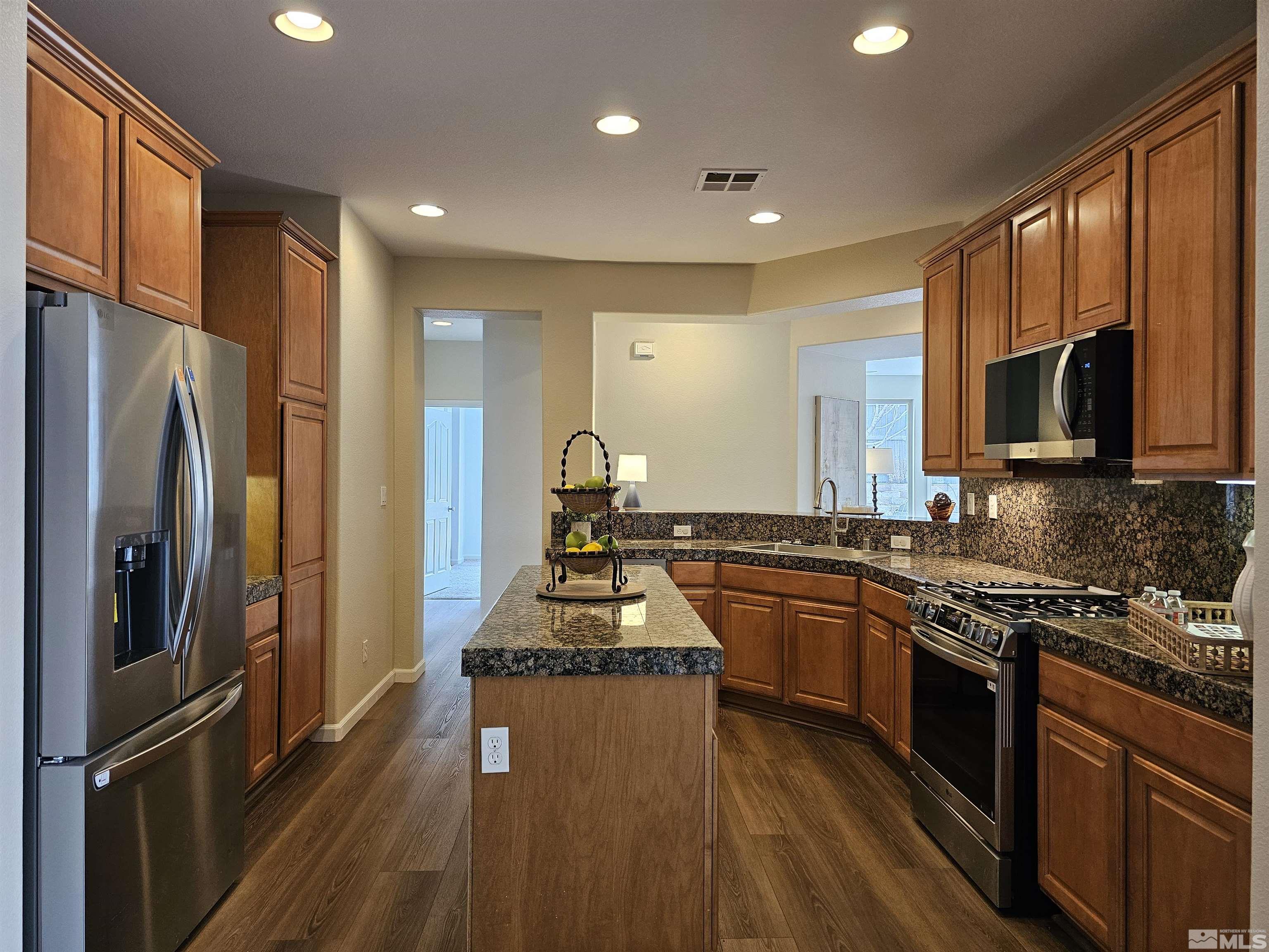 540 Beckfield Court Reno, NV 89521 - Photo 7 of 23 a kitchen with stainless steel appliances granite countertop a stove refrigerator and microwave