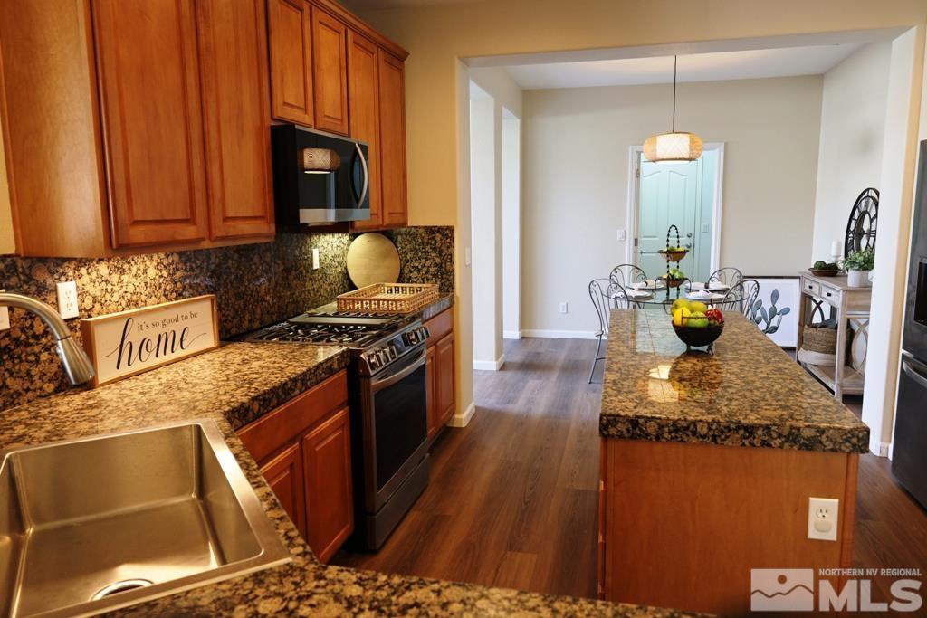 540 Beckfield Court Reno, NV 89521 - Photo 8 of 23 a kitchen with stainless steel appliances granite countertop a stove a sink and a microwave