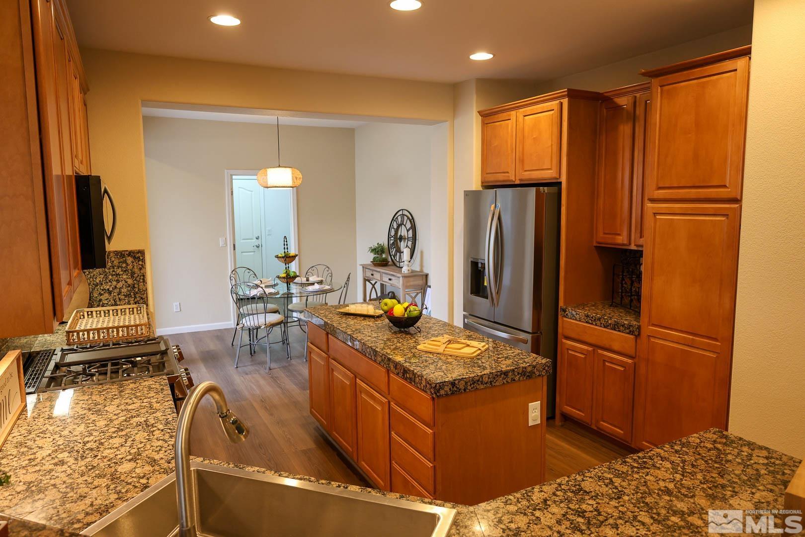 540 Beckfield Court Reno, NV 89521 - Photo 9 of 23 a kitchen with stainless steel appliances granite countertop a refrigerator and a stove