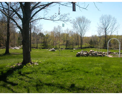 1081 Hill Road Boxborough, MA 01719 - Photo 7 of 8 a backyard of a house with lots of green space
