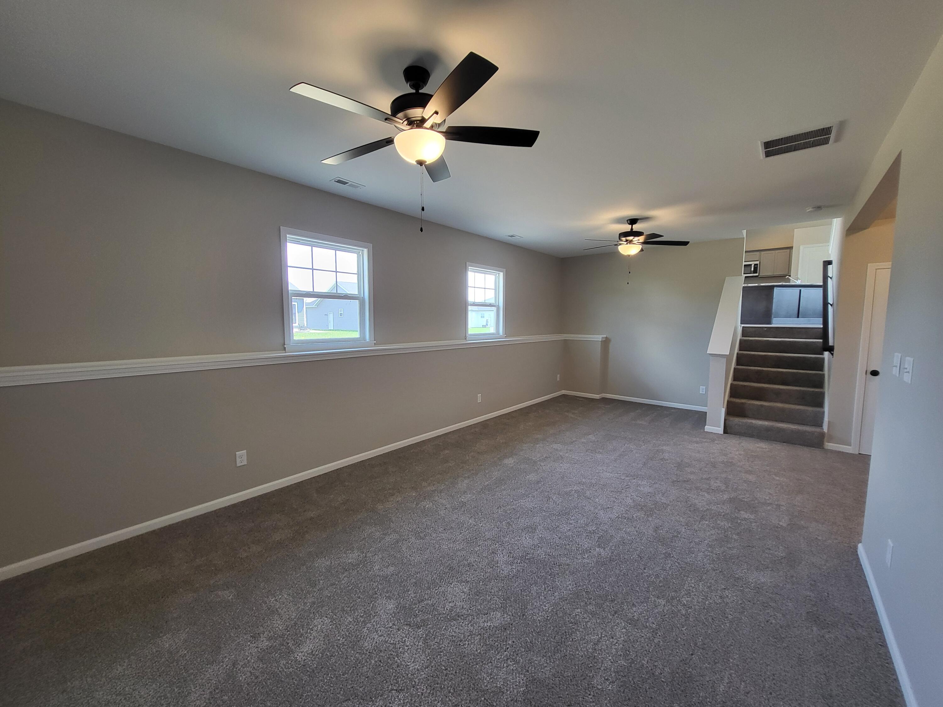 18425 Alexander Avenue Lowell, IN 46356 - Photo 12 of 34 an empty room with stairs and windows