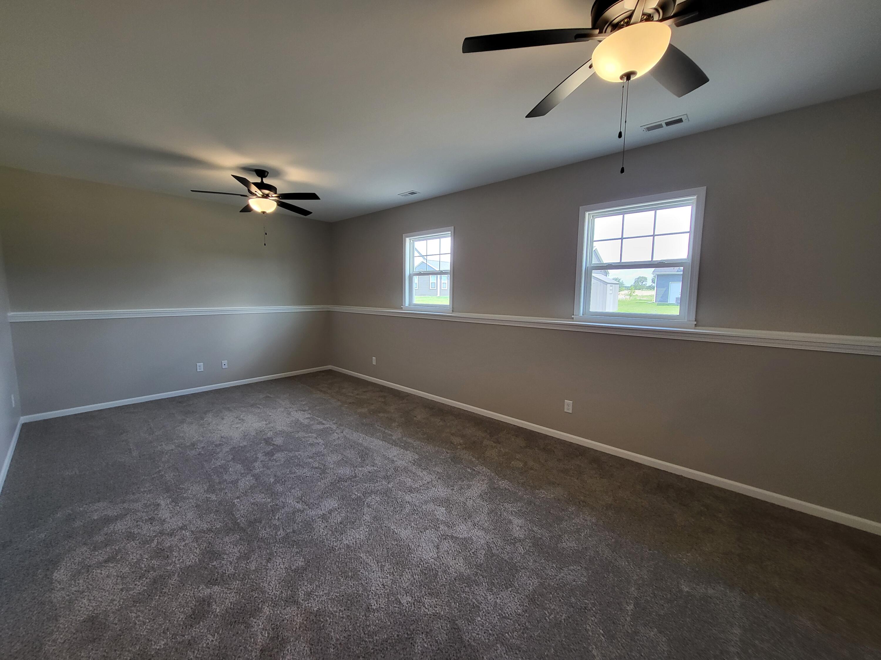 18425 Alexander Avenue Lowell, IN 46356 - Photo 13 of 34 an empty room with windows and chandelier fan